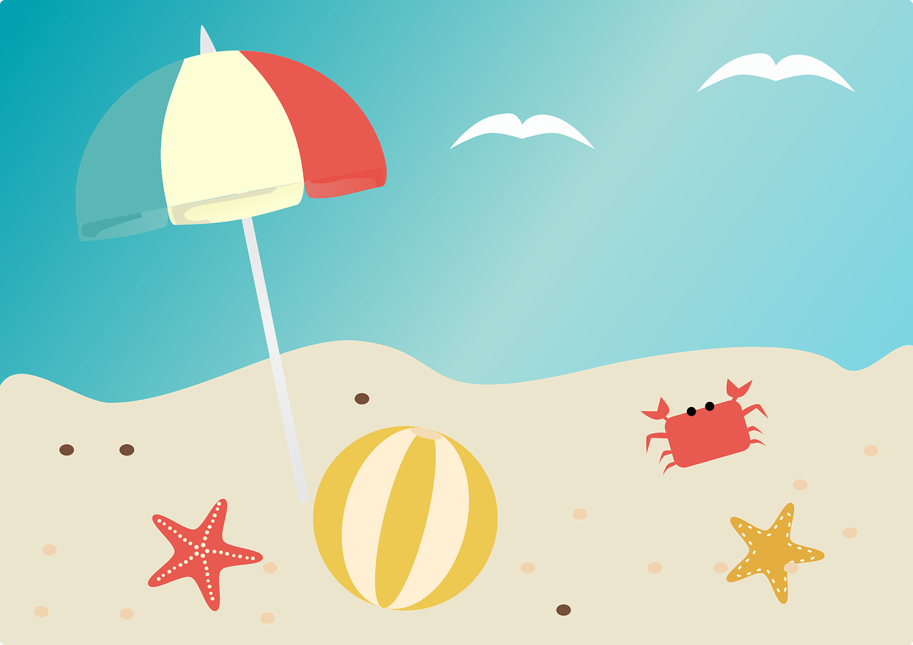 Plaża, na której widać parasol przeciwsłoneczny oraz zabawki w piasku. W oddali jest niebieskie morze.